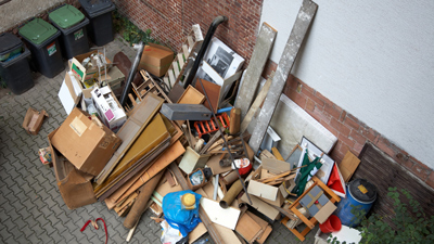 estate flats courtyard piled with house clearance and junk